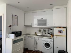 a kitchen with a sink and a washing machine at Charming apartment in Principle Real in Lisbon