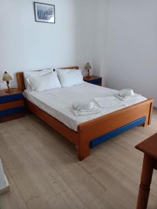 a bedroom with a bed with two nightstands and two tables at Sea View Studios Bali Harbour Beach in Balíon