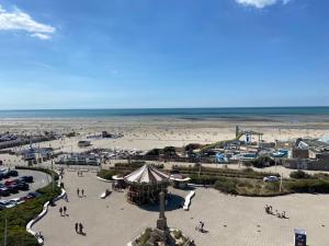 a view of a beach with a tent and the ocean at Marina in Le Touquet-Paris-Plage