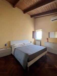 a bedroom with a large bed with a blue blanket at Malies B&B in Benevento