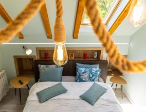 a bedroom with a large bed with blue pillows at Vila Rustic INN Bucegi in Pietroşiţa +29 photos