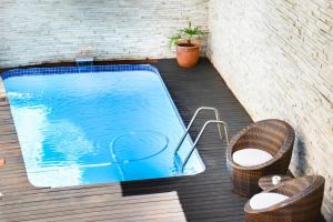 a swimming pool on a deck with two wicker baskets at Signal Hill Lodge in Cape Town