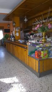 a bar in a restaurant with a counter top at Hotel Cantaleone in San Michele allʼAdige