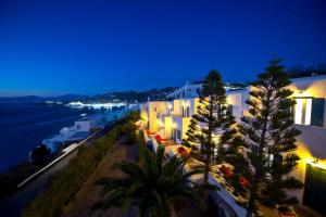 a view of a city at night with white buildings at AEGEAN in Mikonos