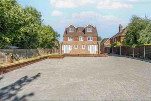 a large brick driveway in front of a large house at Corporate Suite in Hookwood
