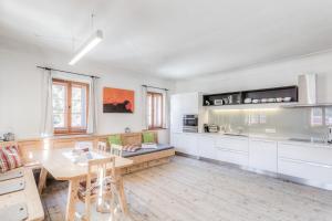 a kitchen with a table and a dining room at Exclusive Apartment Tassenbacherhof in Strassen