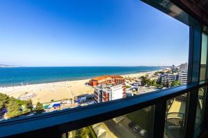 a view from a window of a beach and the ocean at Grand Hotel Sunny Beach - All Inclusive in Sunny Beach