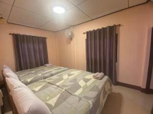 Postel nebo postele na pokoji v ubytování โพธิ์ทองริมทุ่ง Pothong Rimtung Hotel