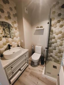 a bathroom with a sink and a toilet and a shower at Lovely apartment Nadolnik in Poznań