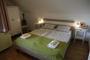 a bedroom with a bed with towels on it at Family apartment on Repečnik farm in Gorje, Bled in Zgornje Gorje