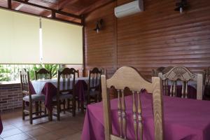a dining room with a table with purple table cloth at Hostal Dulcinea in Esquivias