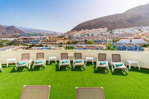 a group of chairs sitting on the roof of a building at Klayman Olivina Aparthotel in Los Cristianos +37 photos