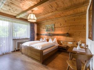 ツェル・アム・ツィラーにあるApartments Fleidlの木製の天井が特徴のベッドルーム1室(大型ベッド1台付)