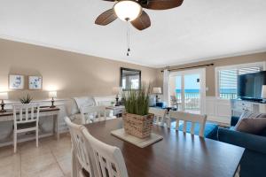 a dining room and living room with a table and chairs at Holiday Surf and Racquet Club 319 in Destin