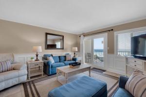 a living room with a couch and a tv at Holiday Surf and Racquet Club 319 in Destin