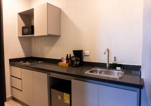 a kitchen with a sink and a counter top at The Garden by DOT Suites in Santa Marta