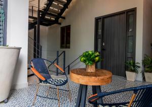 a patio with two chairs and a table on a porch at The Garden Suites in Santa Marta