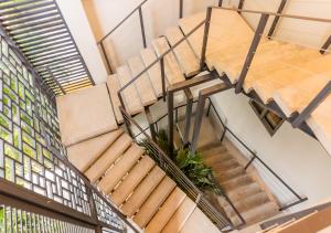 an image of a staircase in a building at The Garden by DOT Suites in Santa Marta