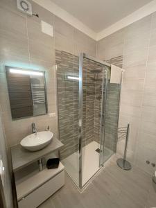 a bathroom with a glass shower and a sink at Anfra B&B in Naples +32 photos