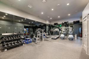 a gym with several treadmills and machines in it at The Stella in New Orleans