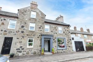 an old stone house on the street at The Auld Sweetie Shop in Perth