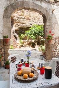 a white table with food on it in an archway at Profumo di Zagara in Lentini