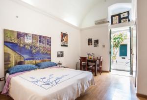 a bedroom with a large bed and a table at Profumo di Zagara in Lentini