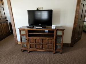 a tv sitting on top of a wooden entertainment center at The Inn at Shady Lawn in Newland