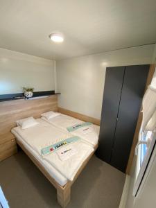 a small bed in a small room with at Beach house Danica - resort & tavern BAIN, free transport, pool, Island of Žut - Kornati in Pristanišće +112 photos