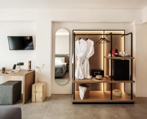 a dressing room with a mirror and a bed at Neapolis 21 Suites, Premium Key Collection in Skiathos Town