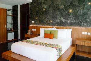 1 dormitorio con 1 cama blanca grande con almohada naranja en Zenubud, en Ubud