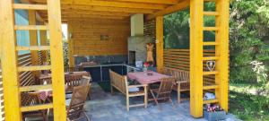 a patio with a table and chairs and a kitchen at Apartment Sobe Ravbar in Novo Mesto