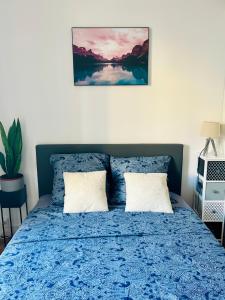 a bedroom with a blue bed with two pillows at NICE - Central 100m plage- Negresco - IDEAL COUPLE in Nice