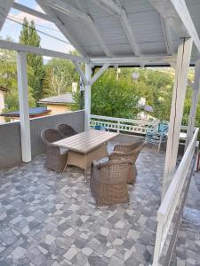 a patio with a wooden table and chairs on a patio at Vila zvjezda 2 in Jajce