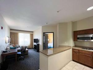 a hotel room with a kitchen and a living room at Studio 6 Carlsbad CA in Carlsbad