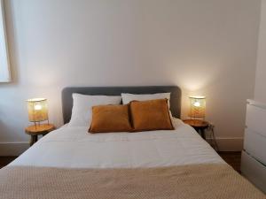 sypialnia z białym łóżkiem z 2 lampami w obiekcie Stunning Apartment Marquês de Pombal w Lizbonie
