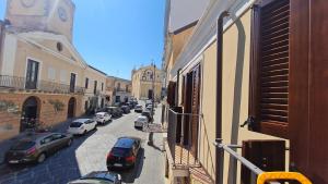 a street with cars parked on the side of the road at Casa Ruicella in Crotone