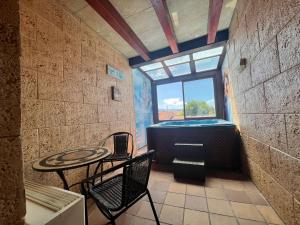 a room with a table and a tub in a room at Hotel Casa Rural SPA La Villa in Ávila