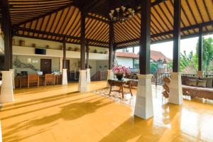 a large pavilion with a table and chairs at Best Western Premier Agung Resort Ubud in Ubud
