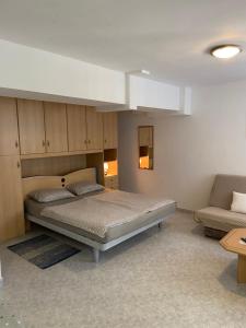 a bedroom with a bed and a couch at Apartments Joka 487 in Rovinj