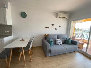 a living room with a couch and a table at Precioso apartamento en primera línea de mar in L'Escala +15 photos