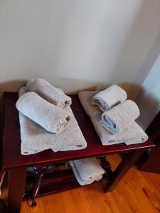 a red table with towels on top of it at Brandys beach house bettys bay in Bettyʼs Bay