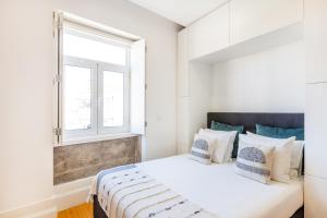 ポルトにあるLifestyle Studio in Porto by BnBirdの白いベッドルーム(ベッド1台、窓付)