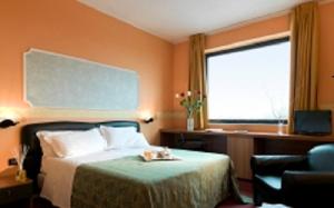 Postel nebo postele na pokoji v ubytování Hotel Bifi