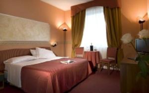 Postel nebo postele na pokoji v ubytování Hotel Bifi