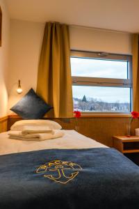 a bedroom with a bed with a large window at Botel Racek in Prague