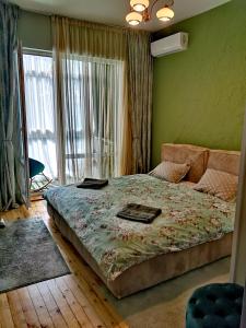 una camera con un letto in una stanza con una finestra di The Best Place in the heart of Sofia City center a Sofia