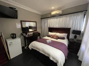 A bed or beds in a room at @Grace Guesthouse