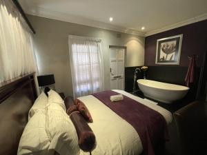A bed or beds in a room at @Grace Guesthouse
