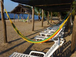 a group of lounge chairs on a beach at Amatique Bay Hotel in Puerto Barrios